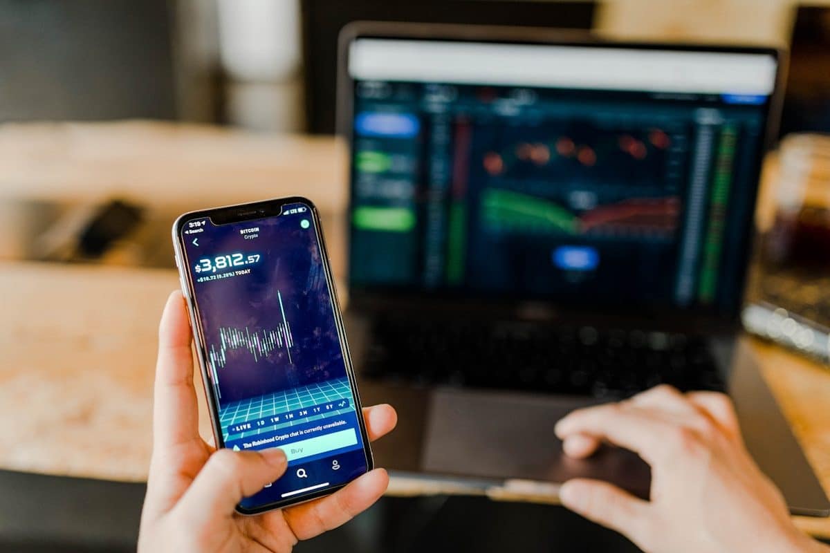 La rébellion silencieuse contre la surautomation dans la Fintech person using phone and laptop computer